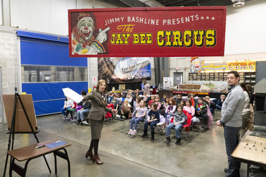 Tammy Shuey, Butler Eagle publisher and general manager, talks with second-grade students from Broad Street Elementary School as they learn about the newspaper business and check out Jimmy Bashline’s Jay Bee Circus during a tour of Butler Eagle Printing Company’s headquarters Wednesday, Dec. 11, 2024. (Rob McGraw/Butler Eagle)