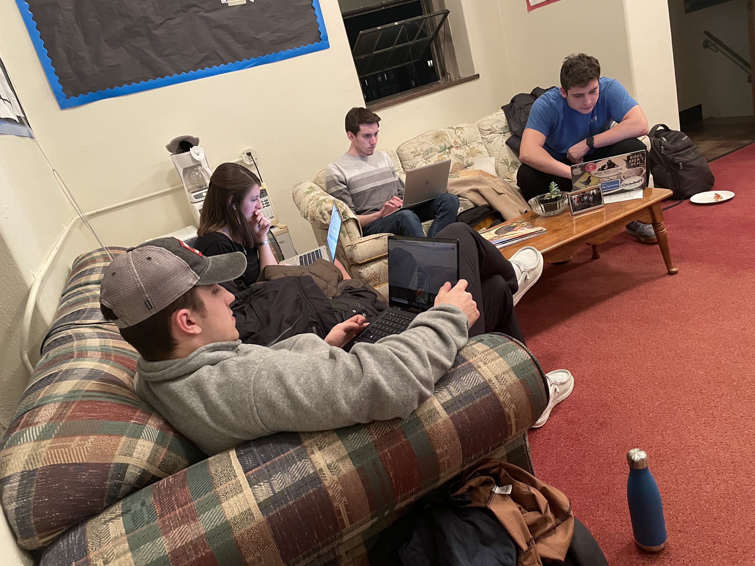 Collegian staffers work on stories on well-worn couches amid pizza detritus in the Keystone Student Media Award-winning weekly’s office in the tower of Crawford