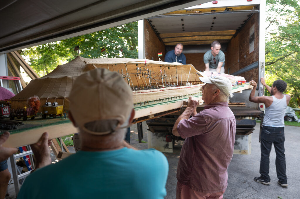 Rue Snyder, 77, lower center, helps guide the Jimmy Bashline Hand Carved Miniature Circus into the back of a Butler Eagle box truck for transport to the Eagle Printing Co. for temporary storage. The circus model has been moved numerous times over the last nearly 90 years. (Cary Shaffer/Butler Eagle)