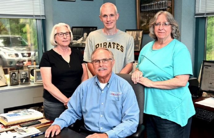 Mirror Publisher Dan Slep is surrounded by, from left, Stephanie Miller, Todd Miller and Deb Miller. (Patrick Waksmunski/Altoona Mirror)